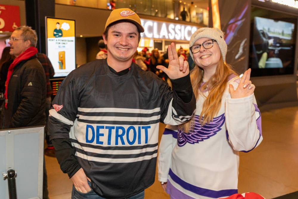 Two alums smiling together for a photo.